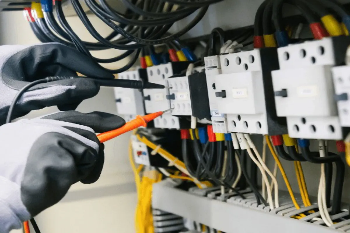 Elektrotechniker verkabelt einen Verteilerschrank auf der Baustelle